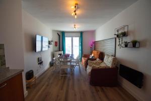 a living room with a couch and a table at SnowGranada Parking telecabina Pradollano Include in Sierra Nevada