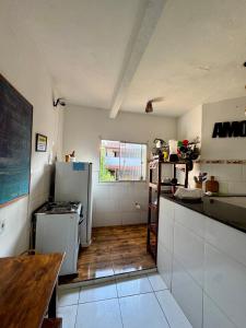una cucina con un frigorifero e un tavolo di Casa Boa Vida GuestHouse a Itacaré
