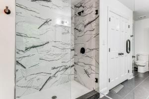 a bathroom with a marble shower with a toilet at Woodsy Concord Retreat about 11 Mi to Nascar! in Concord +28 photos