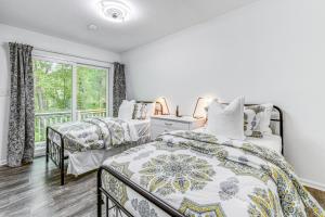 a bedroom with two beds and a window at Woodsy Concord Retreat about 11 Mi to Nascar! in Concord