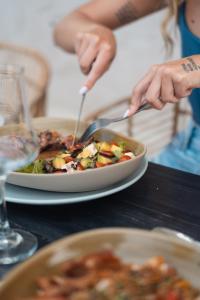 a person eating a bowl of food on a table at Porto Marina Hotel in Guatapé