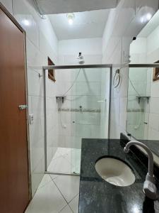 a bathroom with a glass shower and a sink at Casa Boa Vida GuestHouse in Itacaré +28 photos