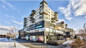 a tall apartment building with a lot of windows at Modern 1BR Flat in Oslo - Central & connected in Oslo