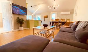 a living room with a couch and a table at KingstonStays The Neighbourhood, Expansive loft, free parking in Kingston