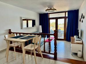 a dining room with a table and two chairs at Tamarán 309 in Playa del Ingles