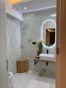 a bathroom with a sink and a mirror at AmyMamaia marina blue in Mamaia +42 photos