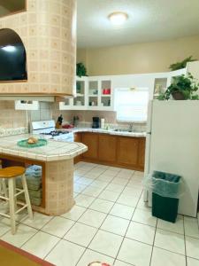a kitchen with a refrigerator and a table in it at Studio-Bay access-Pet friendly in Gulf Shores