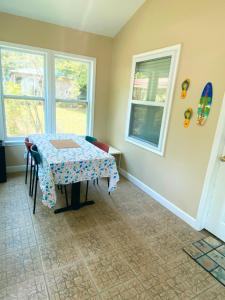 a dining room with a table and two windows at Studio-Bay access-Pet friendly in Gulf Shores