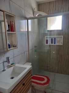 a bathroom with a shower with a sink and a toilet at Casa da Tranquilidade in Barra Velha