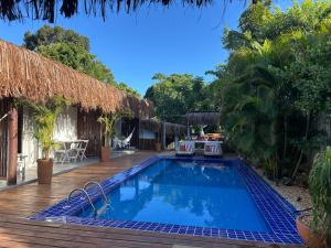a resort with a swimming pool and a deck at VILA TRANCOSEAR in Trancoso