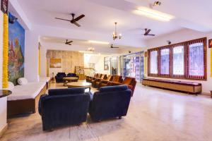 a living room with couches and chairs and a table at Townhouse Pichola Formerly Vinayak in Udaipur