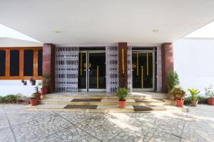 a lobby of a building with doors and potted plants at Townhouse Pichola Formerly Vinayak in Udaipur +42 photos