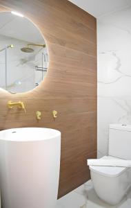 a bathroom with a white toilet and a sink at Pepe Lux Ático centro de Málaga in Málaga