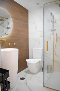 a bathroom with a toilet and a glass shower at Pepe Lux Ático centro de Málaga in Málaga +20 photos