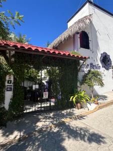 a restaurant with a gate in front of a building at Casa Bastin in Puerto Escondido