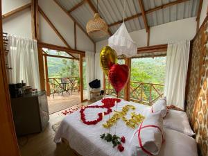 a bedroom with a bed with a bunch of balloons at cabañas tamborillo in La Vega