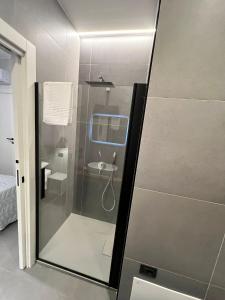 a bathroom with a glass shower with a sink at Atto Primo - B&B Experience in Milazzo +32 photos