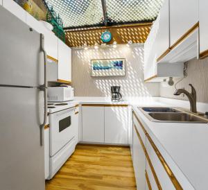 a kitchen with white cabinets and a sink at North Shore Private Beach Frontage in Spring Lake
