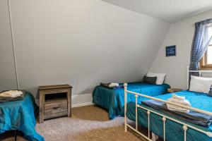 a room with two beds and a night stand in a room at Loch Nez, a spacious 3-bedroom home in Silver Lake, MI in Mears