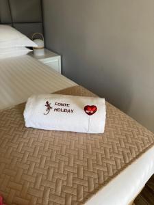 a towel sitting on top of a bed at Fonte Retreat Premium Suite in Sandim +43 photos