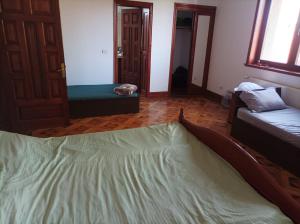 a living room with a bed and a couch at Casa de vacanta in Târgu Jiu