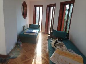 a living room with two beds and a couch at Casa de vacanta in Târgu Jiu