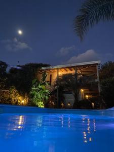 a villa with a swimming pool at night at Mandalas de Mar in Punta Del Diablo