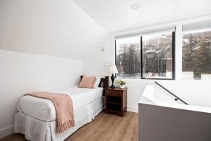 a white bedroom with a bed and a window at Unbeatable Location, Sleeps 12, Ski Access Across the Street, Large Hot Tub, Walk to the Lift in Park City +52 photos