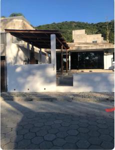 a white building with a roof on top of it at Residencial da Ju in Bombinhas