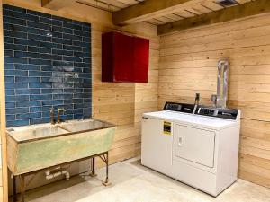a kitchen with a sink and a stove at The Arete Hostel and Suites in Summersville