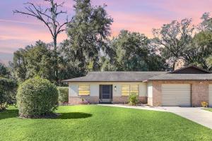 a brick house with a garage in a yard at Cozy Villa with Spacious Outdoor Space in Orange City