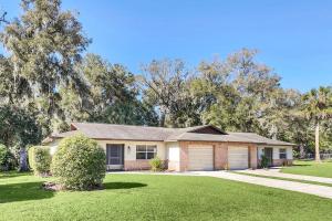 a house with a garage on a green yard at Cozy Villa with Spacious Outdoor Space in Orange City