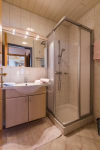 a bathroom with a shower and a sink at Aparthaus Birkenheim in Filzmoos