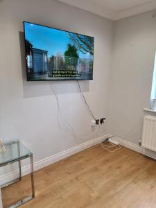 a flat screen tv hanging on a white wall at Rays Lodge 2 in Middlesbrough