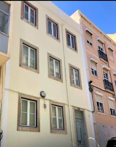 a building with many windows on the side of it at Hostel Arroios in Lisbon