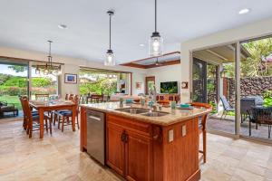 an open kitchen and dining room with a table and chairs at 518 Villages at Mauna Lani in Waikoloa