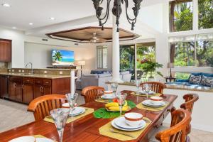 a kitchen and living room with a wooden table and chairs at B4 Palm Villas at Mauna Lani in Waikoloa