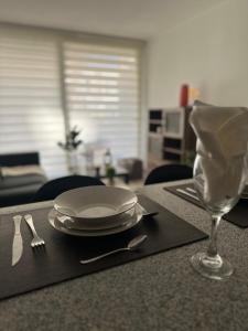 a table with a plate and a wine glass on it at Basq Propiedades - Barrio Republica 7 in Santiago