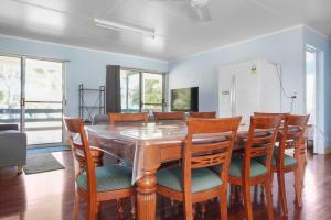 a dining room with a wooden table and chairs at Sorrento on Jeffery in Agnes Water