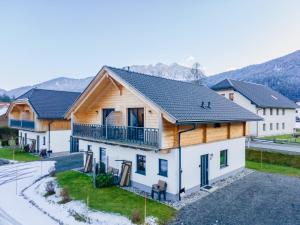 an image of a house with a mountain in the background at Rattendorf 3B in Rattendorf