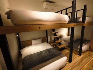 Katil atau katil-katil dalam bilik di Hakuba Ryujin Onsen RYOKAN SUI