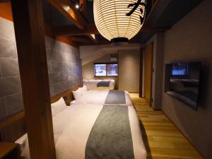 Katil atau katil-katil dalam bilik di Hakuba Ryujin Onsen RYOKAN SUI