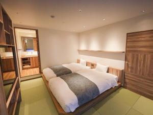 Katil atau katil-katil dalam bilik di Hakuba Ryujin Onsen RYOKAN SUI