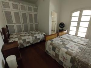 Postel nebo postele na pokoji v ubytování Casa Eventos e Temporada com 3 suites, piscina, churrasqueira, Wi-Fi, Ar Condicionado - Proximo Praia Mar Casado e Pernambuco - Guaruja