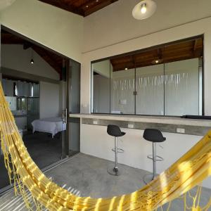 a room with a hammock in a house at Chalés Encanto in Sao Jorge