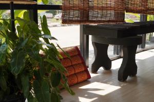 a plant sitting next to a black table next to a window at Naraya Resort in Ko Lanta