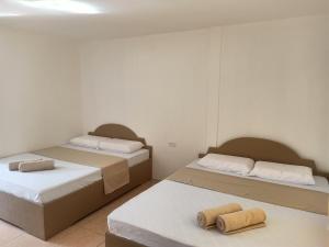 two beds in a room with two mattresses at Alona Guest House in Panglao Island