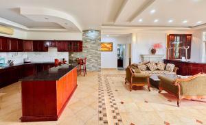 a kitchen and living room with a couch and a table at DOHA GARDEN Hotel & Villa VT in Vung Tau