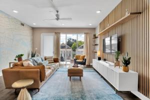 a living room with a couch and a tv at Bywater Condo W Pool & Gym Access in New Orleans