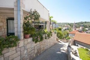 a building with plants on the side of it at Two Bedroom Apartment with Terrace A1 in Splitska